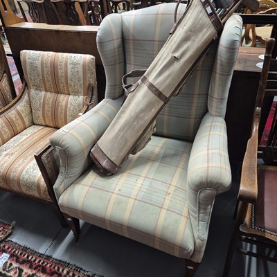 Lot 818 - A wing back armchair.