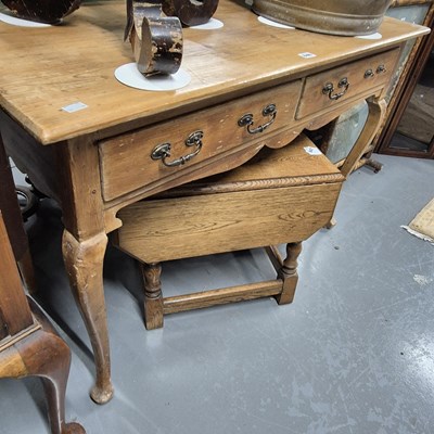 Lot 846 - A pine two drawer side table on cabriole legs....
