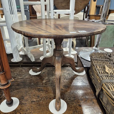 Lot 875 - A 19th century mahogany low tripod table.