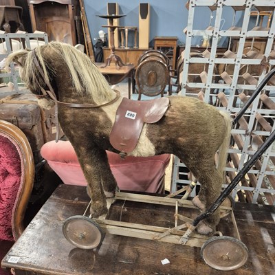 Lot 880 - A vintage toy wheeled horse.