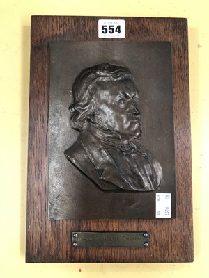 Lot 554 - An oak backed bronze profile plaque of William...