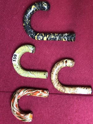 Lot 159 - Four bakelite walking stick handles.