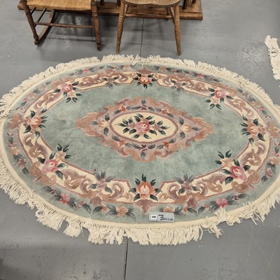 Lot 965 - A Chinese oval small carpet