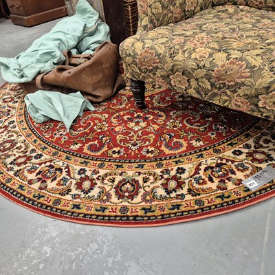Lot 971 - A machine made circular rug of persian design
