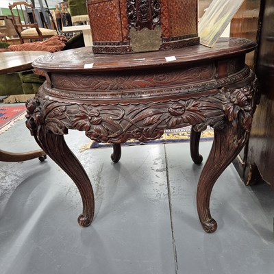 Lot 902 - An oriental carved hardwood circular centre table