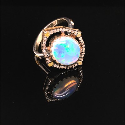 Lot 173 - A silver gilt ring set with an oval cabochon...