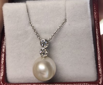 Lot 175 - A pearl and diamond necklace. The diamonds are...