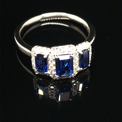 Lot 180 - A platinum hallmarked step cut blue sapphire...