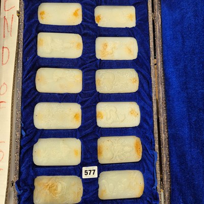 Lot 577 - A set of twelve glass reliefs of oriental panels