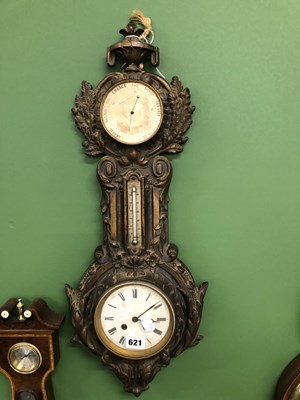 Lot 621 - A clock barometer in cast metal case