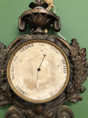 Lot 621 - A clock barometer in cast metal case