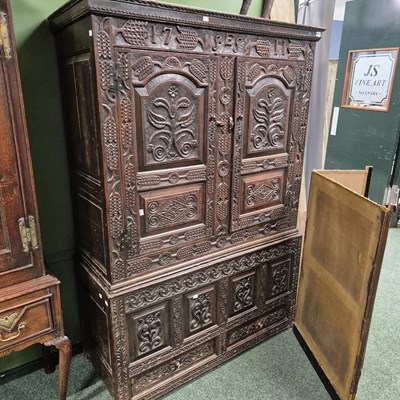 Lot 662 - An 18th century carved oak livery cupboard....