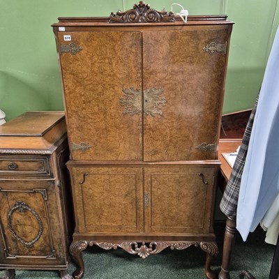 Lot 674 - A walnut cocktail cabinet. H154 x W90 x D49cm