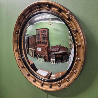 Lot 677 - A convex wall mirror