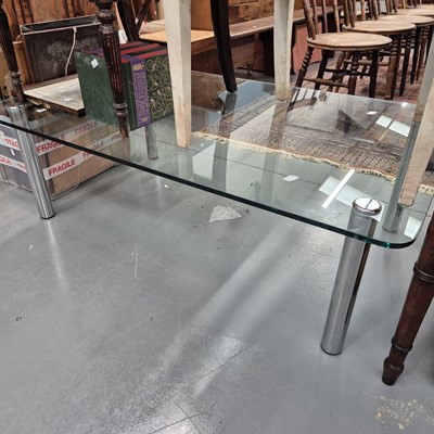 Lot 701 - A glass top coffee table.