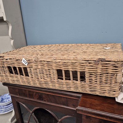 Lot 712 - A vintage wicker basket. H16 x W63 x D31cm