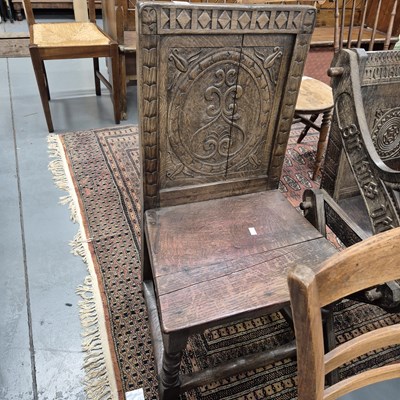 Lot 715 - An 18th century carved oak hall chair.