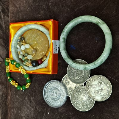 Lot 192 - Two hardstone green bangles, a hardstone...