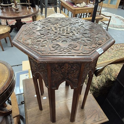 Lot 1122 - A carved occasional table