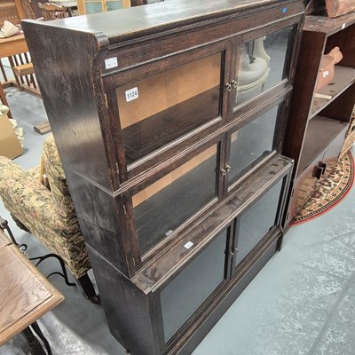 Lot 1124 - An oak sectional bookcase