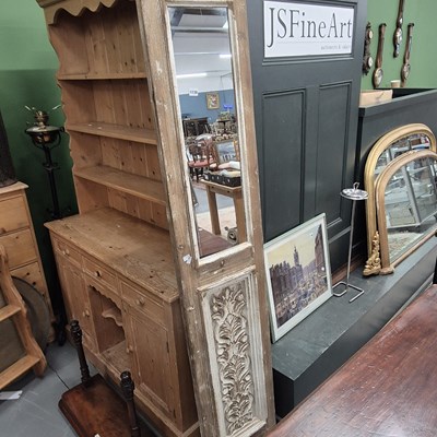 Lot 1139 - A carved framed long wall mirror.