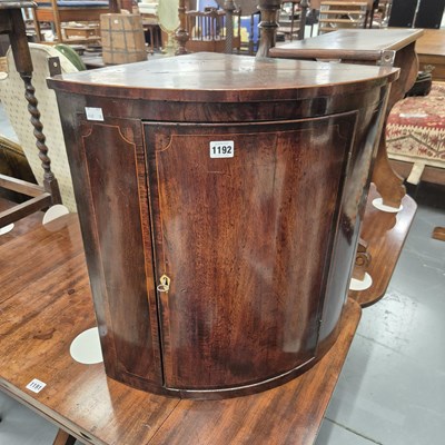 Lot 1192 - A small bow front mahogany corner cabinet