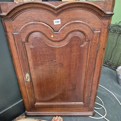 Lot 1197 - A Geo. III oak corner cabinet
