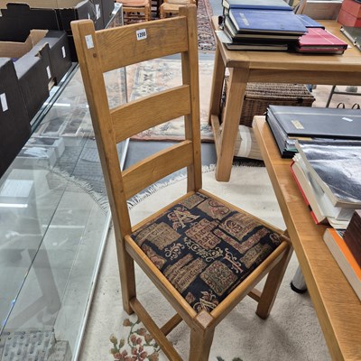 Lot 1200 - A set of four oak heavy ladderback chairs.
