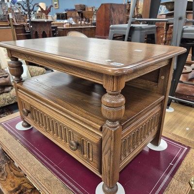 Lot 1039 - An ercol coffee table and a faux ostrich hide...