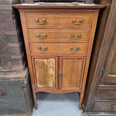 Lot 1056 - An inlaid mahogany music cabinet