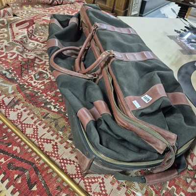 Lot 1078 - A canvas and leather holdall