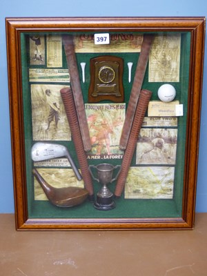 Lot 397 - A framed golfing diorama backed by advertising...