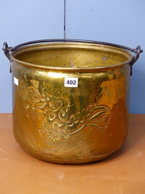 Lot 402 - A cylindrical brass coal bucket over swung by...
