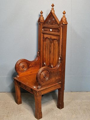 Lot 407 - A Gothic style pine throne, the panelled back...
