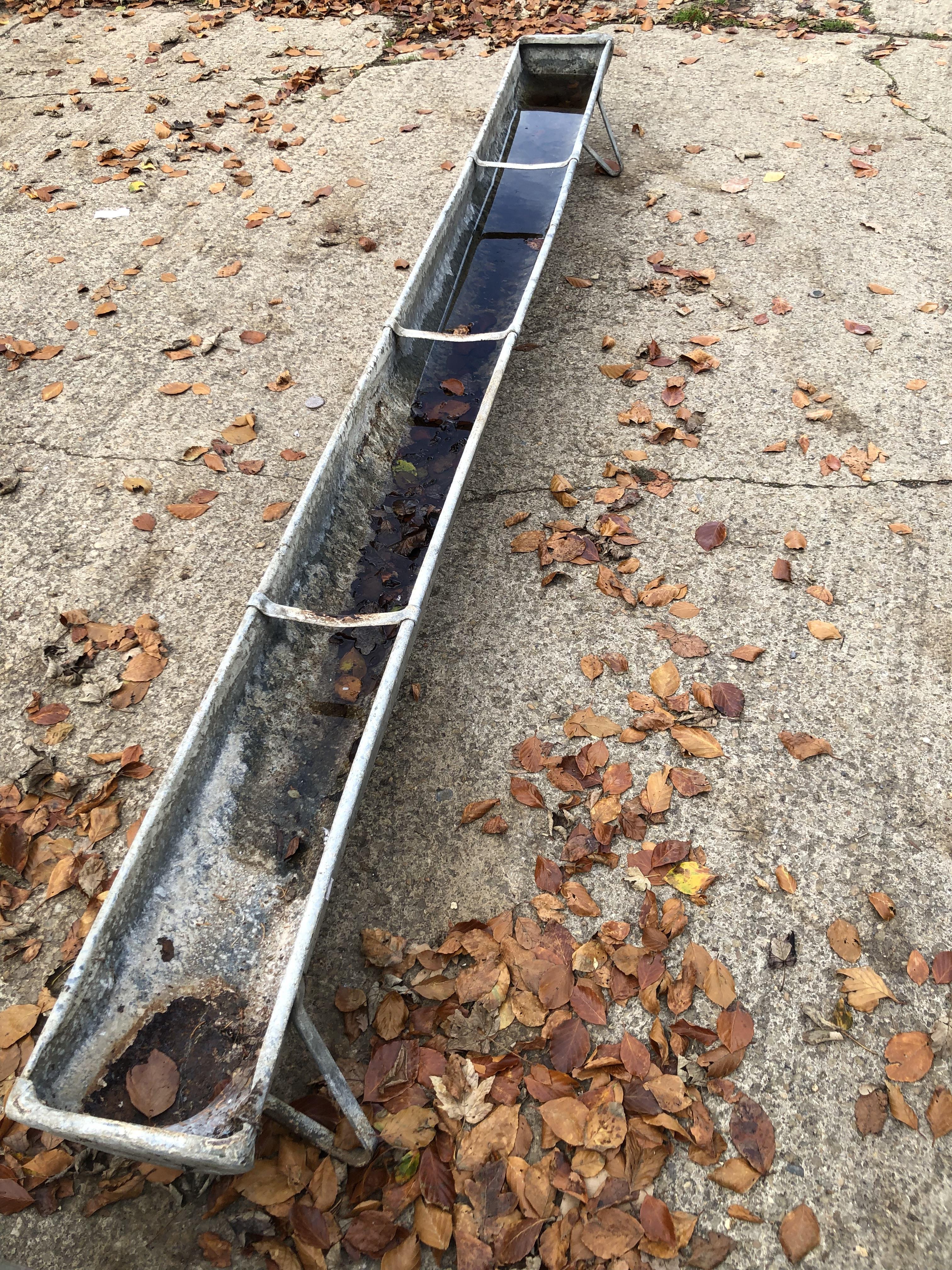 Lot 633 - Two galvanised metal troughs, together with