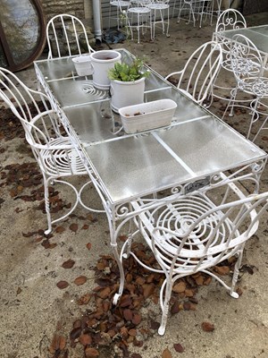 Lot 636 - A large garden glass topped wrought iron table,...