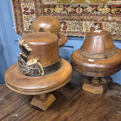 Lot 521 - Three carved mahogany shop display model hats...