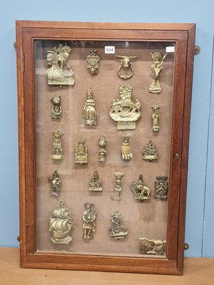 Lot 534 - A collection of brass door knockers displayed...
