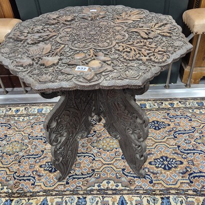 Lot 537 - An Indian relief carved octagonal table on a...