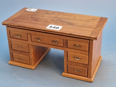 Lot 540 - A mahogany pedestal desk form cigarette box,...