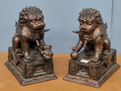 Lot 557 - A pair of Chinese bronze Buddhist lions seated...