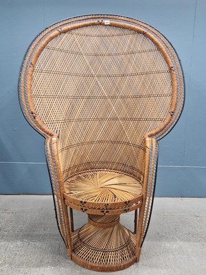 Lot 589 - A basket work armchair, the tall rounded back...