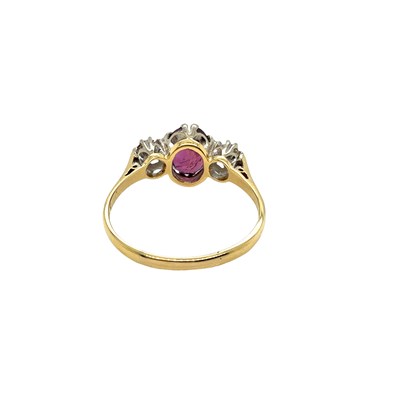 Lot 8 - An 18ct hallmarked gold purple sapphire and...