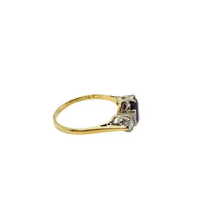 Lot 8 - An 18ct hallmarked gold purple sapphire and...