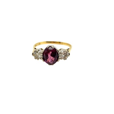 Lot 8 - An 18ct hallmarked gold purple sapphire and...