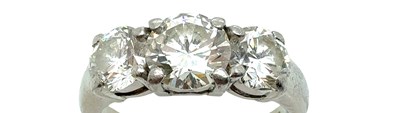 Lot 9 - A platinum hallmarked three-stone diamond,...