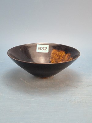 Lot 632 - A Henan type bowl glazed in black with a leaf...