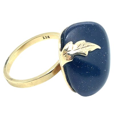 Lot 41 - A handmade blue goldstone ring with an applied...