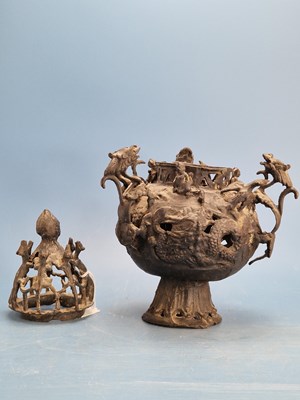 Lot 647 - An Oriental bronze vase and cover pierced and...