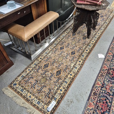 Lot 491 - An oriental runner of Persian design, 324 x 72 cm